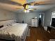 Main bedroom featuring wood floors, ceiling fan, natural light, and ensuite bathroom at 18130 Keene Rd, Altoona, FL 32702