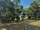 Expansive grassy lot bordered by mature trees, offering privacy and natural beauty at 18130 Keene Rd, Altoona, FL 32702
