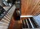 Stairway leading to lower level with wood and tile flooring and white banister at 18130 Keene Rd, Altoona, FL 32702