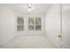 Bright bedroom with two large windows and neutral carpeting and trim at 1860 Park Forest Blvd, Mount Dora, FL 32757