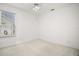 Empty bedroom featuring neutral carpeting, large window, ceiling fan, and bright white walls at 1860 Park Forest Blvd, Mount Dora, FL 32757