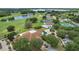 Aerial view of community clubhouse with golf course and swimming pool in the distance at 1860 Park Forest Blvd, Mount Dora, FL 32757