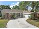 Charming single-story home boasting a circular driveway and meticulously manicured landscaping at 1860 Park Forest Blvd, Mount Dora, FL 32757