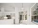 Kitchen with views of the pool, stainless appliances, and white cabinets at 1860 Park Forest Blvd, Mount Dora, FL 32757