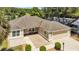 An aerial view showcasing this inviting home with a well-manicured lawn and an extended driveway at 1871 W Schwartz Blvd, Lady Lake, FL 32159