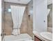 Tile-lined bathtub and shower combination with white shower curtain for added privacy at 1871 W Schwartz Blvd, Lady Lake, FL 32159