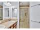 Bright bathroom featuring a double sink vanity and a glass-enclosed shower at 1871 W Schwartz Blvd, Lady Lake, FL 32159