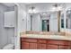 Bathroom vanity features double sinks, wood cabinetry and an enclosed water closet at 1871 W Schwartz Blvd, Lady Lake, FL 32159