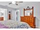 Stylish bedroom displays a large dresser, and an entry into the ensuite primary bathroom at 1871 W Schwartz Blvd, Lady Lake, FL 32159