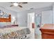 Bedroom with a backyard view also displays a door to the primary bathroom and mirror at 1871 W Schwartz Blvd, Lady Lake, FL 32159