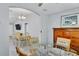 Spacious dining area with glass table set and view into a comfortable sitting room at 1871 W Schwartz Blvd, Lady Lake, FL 32159