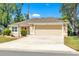 Charming single-story home featuring an attached two-car garage and well-kept lawn at 1871 W Schwartz Blvd, Lady Lake, FL 32159