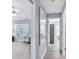 Hallway view featuring wood-look flooring, an art display and entries to the bedroom and living room at 1871 W Schwartz Blvd, Lady Lake, FL 32159