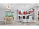 Open-concept kitchen boasts stainless steel appliances, a breakfast bar, and views to a dining area at 1871 W Schwartz Blvd, Lady Lake, FL 32159