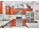 Modern kitchen with stainless appliances, contrasting wood cabinets, and functional layout at 1871 W Schwartz Blvd, Lady Lake, FL 32159