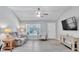 Sunlit living room showcases neutral color palette, modern ceiling fan, and attractive gray flooring at 1871 W Schwartz Blvd, Lady Lake, FL 32159