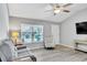 Bright living room features vaulted ceiling, neutral decor, and stylish, durable gray flooring at 1871 W Schwartz Blvd, Lady Lake, FL 32159
