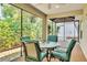 Relaxing screened patio with seating for four and views of lush greenery at 1871 W Schwartz Blvd, Lady Lake, FL 32159