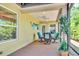 Covered patio featuring a table, four chairs, and a view of the landscaped backyard at 1871 W Schwartz Blvd, Lady Lake, FL 32159