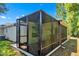 Enclosed screened patio offering a private and comfortable outdoor living space at 1871 W Schwartz Blvd, Lady Lake, FL 32159