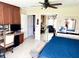 Spacious bedroom boasts ceiling fan, desk area, and an ensuite bathroom with natural lighting at 1875 Oxford Ln, The Villages, FL 32162
