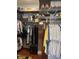Walk-in closet with built-in shelves and hanging rods for optimal organization and storage at 1875 Oxford Ln, The Villages, FL 32162