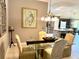 Elegant dining room with glass table and chandelier lighting at 1875 Oxford Ln, The Villages, FL 32162
