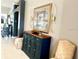 Close up view of a decorated entryway with an accent table and neutral seating at 1875 Oxford Ln, The Villages, FL 32162
