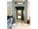 Hallway showcasing modern gray paint, designer touches, and a view of the open concept interior at 1875 Oxford Ln, The Villages, FL 32162