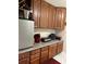 Well-equipped kitchen featuring granite countertops and wooden cabinets at 1875 Oxford Ln, The Villages, FL 32162