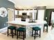 Open kitchen featuring granite counters, stone accents, stainless appliances and bar stool seating at 1875 Oxford Ln, The Villages, FL 32162