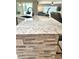 Modern kitchen island features stone accents and electrical outlets at 1875 Oxford Ln, The Villages, FL 32162
