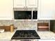 Modern kitchen with stainless steel microwave above stove at 1875 Oxford Ln, The Villages, FL 32162