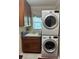 Functional laundry room features a stacked washer and dryer, plus ample cabinet space at 1875 Oxford Ln, The Villages, FL 32162