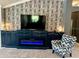 Inviting living room with a fireplace and a patterned accent wall at 1875 Oxford Ln, The Villages, FL 32162