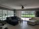 Bright living room with a ceiling fan, comfortable seating, and a glass slider leading to the outdoors at 1875 Oxford Ln, The Villages, FL 32162