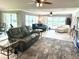 Spacious living room with comfortable seating and sliding glass doors to the outside at 1875 Oxford Ln, The Villages, FL 32162