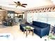 Cozy living room with tile floors, large windows, ceiling fan, and comfortable furnishings at 1875 Oxford Ln, The Villages, FL 32162