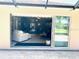 The bi-fold glass doors provide seamless access to the living room, complete with a white couch and plenty of seating at 1875 Oxford Ln, The Villages, FL 32162
