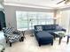 Comfortable living room featuring a sectional sofa, zig zag armchair, and bright natural light at 1875 Oxford Ln, The Villages, FL 32162