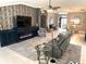 Open concept living room with a decorative wallpaper, entertainment center, and recessed lighting at 1875 Oxford Ln, The Villages, FL 32162
