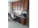 Cozy office nook featuring built-in desk with granite top and ample cabinet space for storage at 1875 Oxford Ln, The Villages, FL 32162