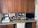 This office space boasts built-in wood cabinets and granite countertops, providing ample storage and workspace at 1875 Oxford Ln, The Villages, FL 32162
