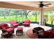 Charming screened patio with outdoor furniture, ceiling fan, and views at 1875 Oxford Ln, The Villages, FL 32162