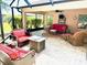 Screened-in porch featuring wicker furniture, ceiling fan, and tiled flooring at 1875 Oxford Ln, The Villages, FL 32162