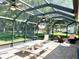 Large screened patio offers ample seating and a picnic table for outdoor entertaining with peaceful backyard views at 1875 Oxford Ln, The Villages, FL 32162