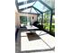 A screened patio with tile flooring and a view of the backyard at 1875 Oxford Ln, The Villages, FL 32162