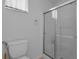 Modern bathroom with glass shower enclosure, commode, and towel ring at 2012 Braxton St, Clermont, FL 34711