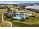 Aerial view of the community pool, clubhouse, lake and golf course at 2012 Braxton St, Clermont, FL 34711