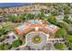 Aerial view of the community clubhouse, pool and parking area with lush landscaping at 2012 Braxton St, Clermont, FL 34711